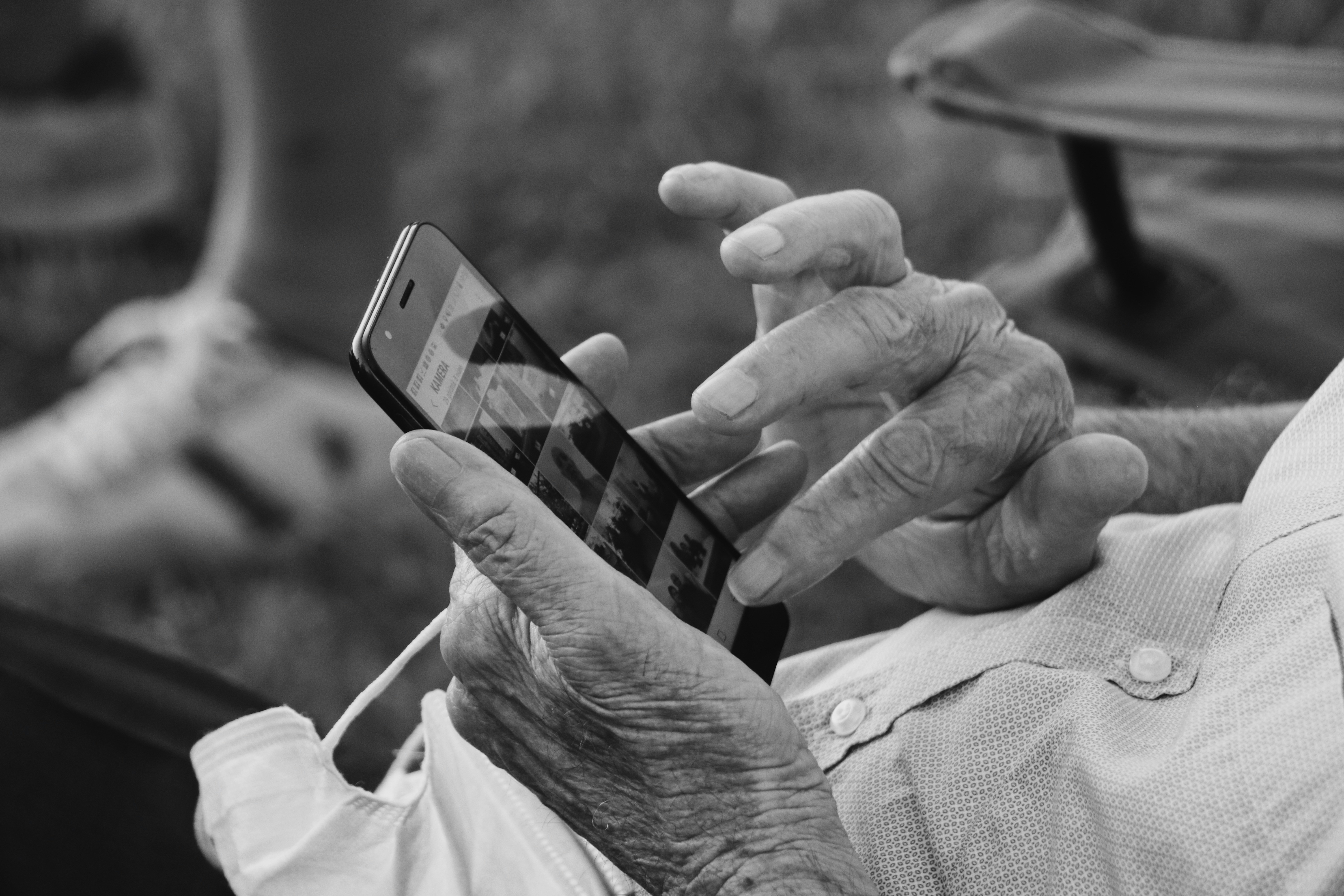 Senior woman using BrightSocial on her smartphone to find community activities in Victoria BC
